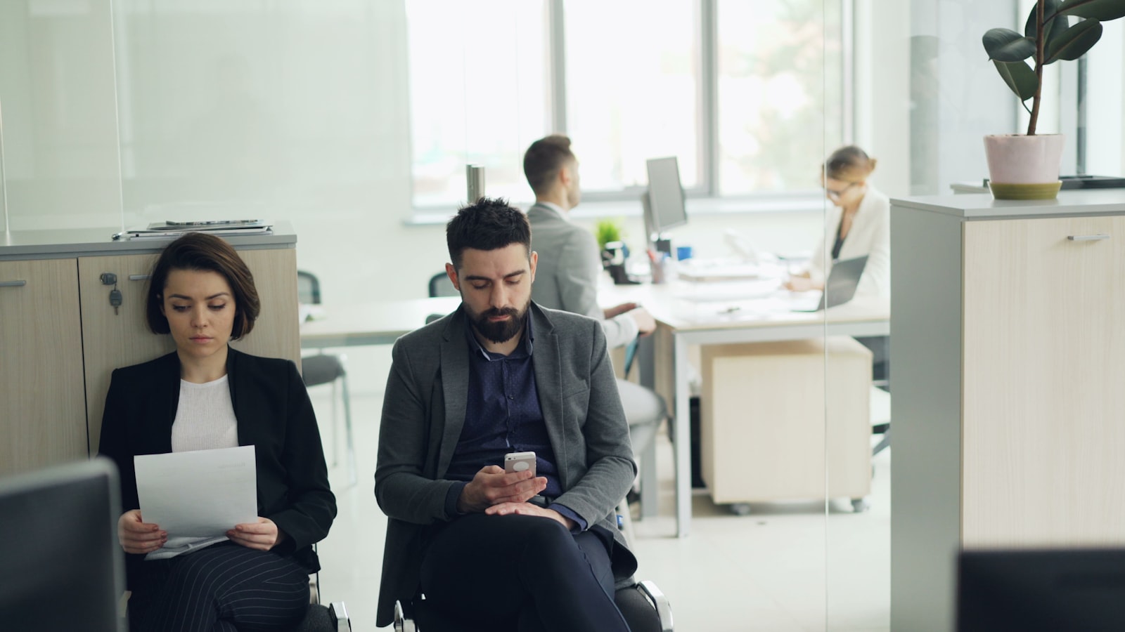 People waiting in a modern office lobby